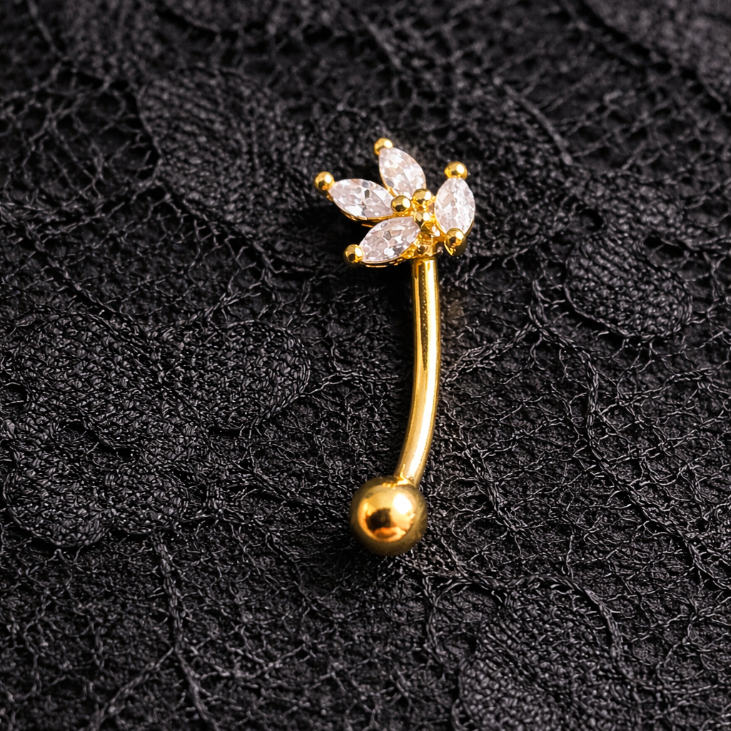 Gold eyebrow/rook bar with floral design on a black lace background