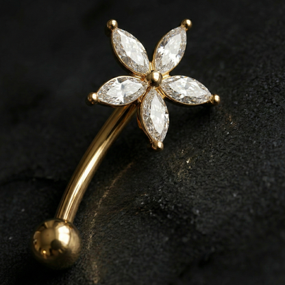 Gold eyebrow/rook barbell with diamond-like stone on a dark background