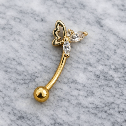 Gold eyebrow/rook barbell wth butterfly design on a marble background