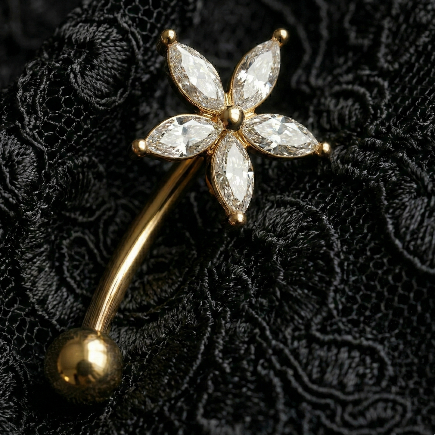 Gold eyebrow/rook with diamond-like star gemstones on a black textured background