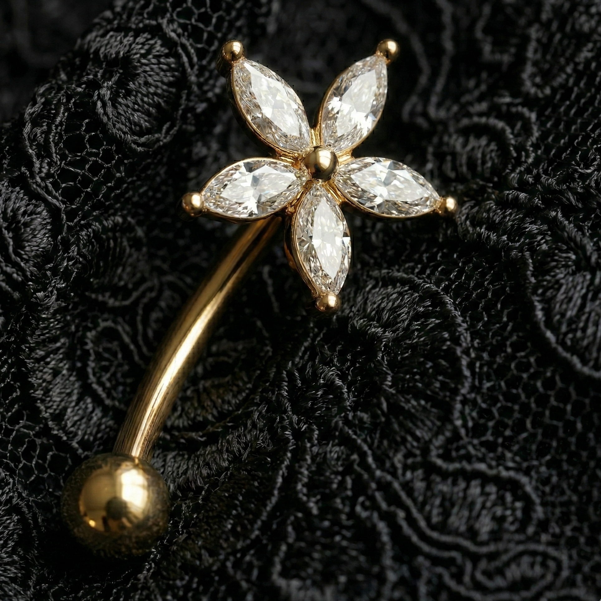 Gold eyebrow/rook with diamond-like star gemstones on a black textured background