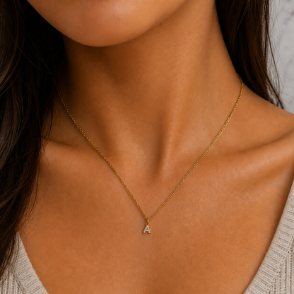 Gold necklace with a small pendant on a person's neck