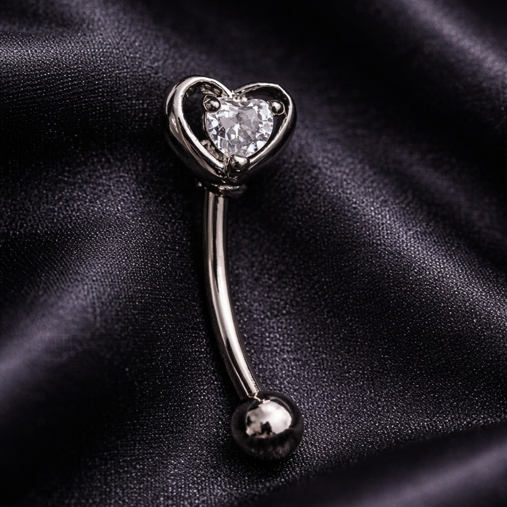 Heart-shaped eyebrow/rook barbell on a black satin background