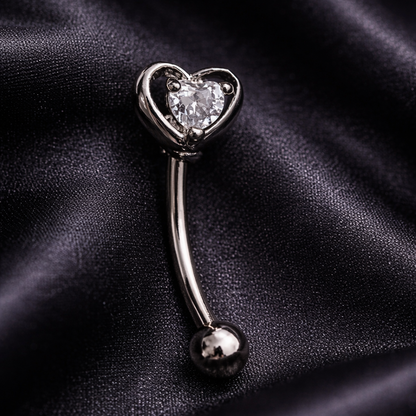 Heart-shaped eyebrow/rook barbell on a black satin background