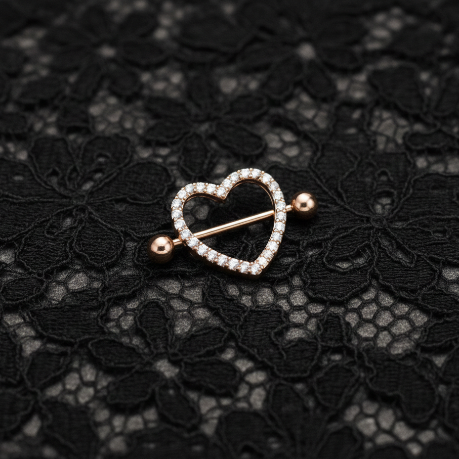 Heart-shaped nipple bars with diamonds on a black lace background