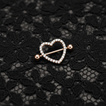 Heart-shaped nipple bars with diamonds on a black lace background