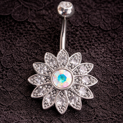 Silver belly button ring with floral design and gemstone on a black lace background