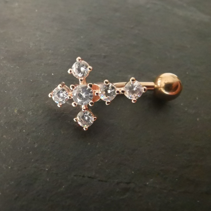 Inverted rose gold cross navel ring made from 14G surgical steel 316L, featuring a dangling crucifix charm and clear cubic zirconia top ball.
