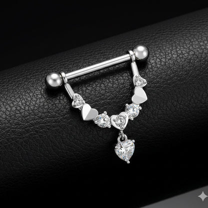 Nipple piercing jewellery with heart-shaped charms on a black leather background