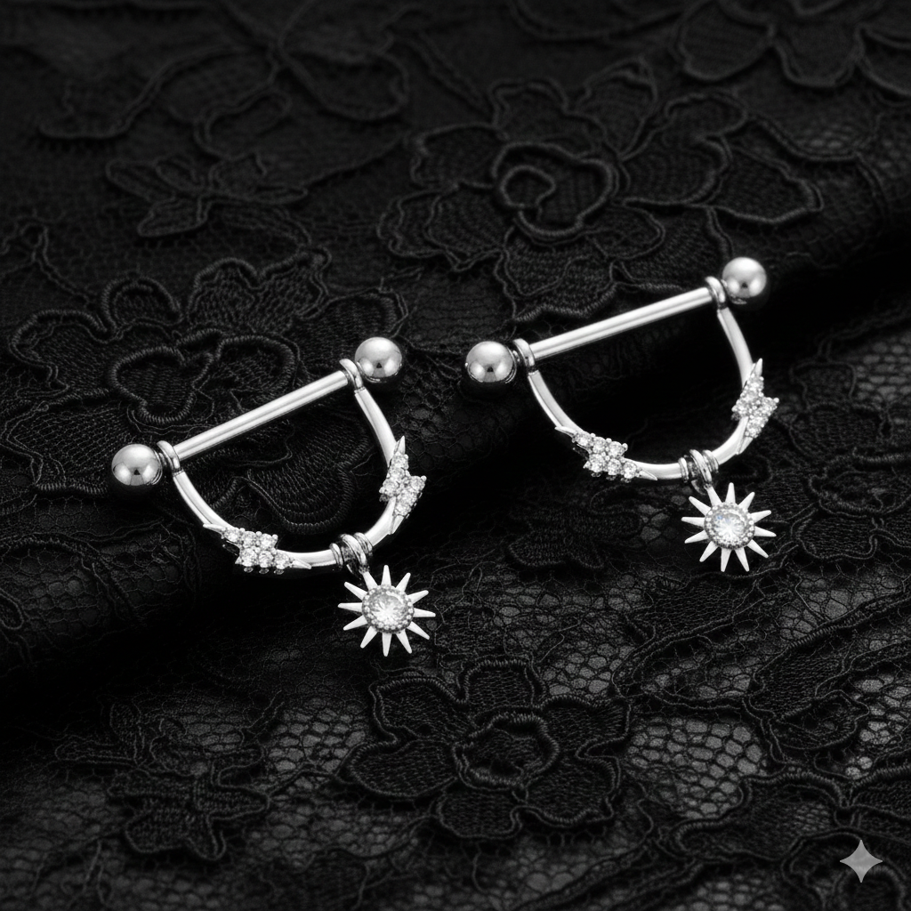 Pair of nipple piercing shields with star designs on a black lace background