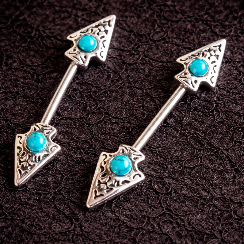 Pair of silver nipple bars with turquoise gemstones on a dark textured background