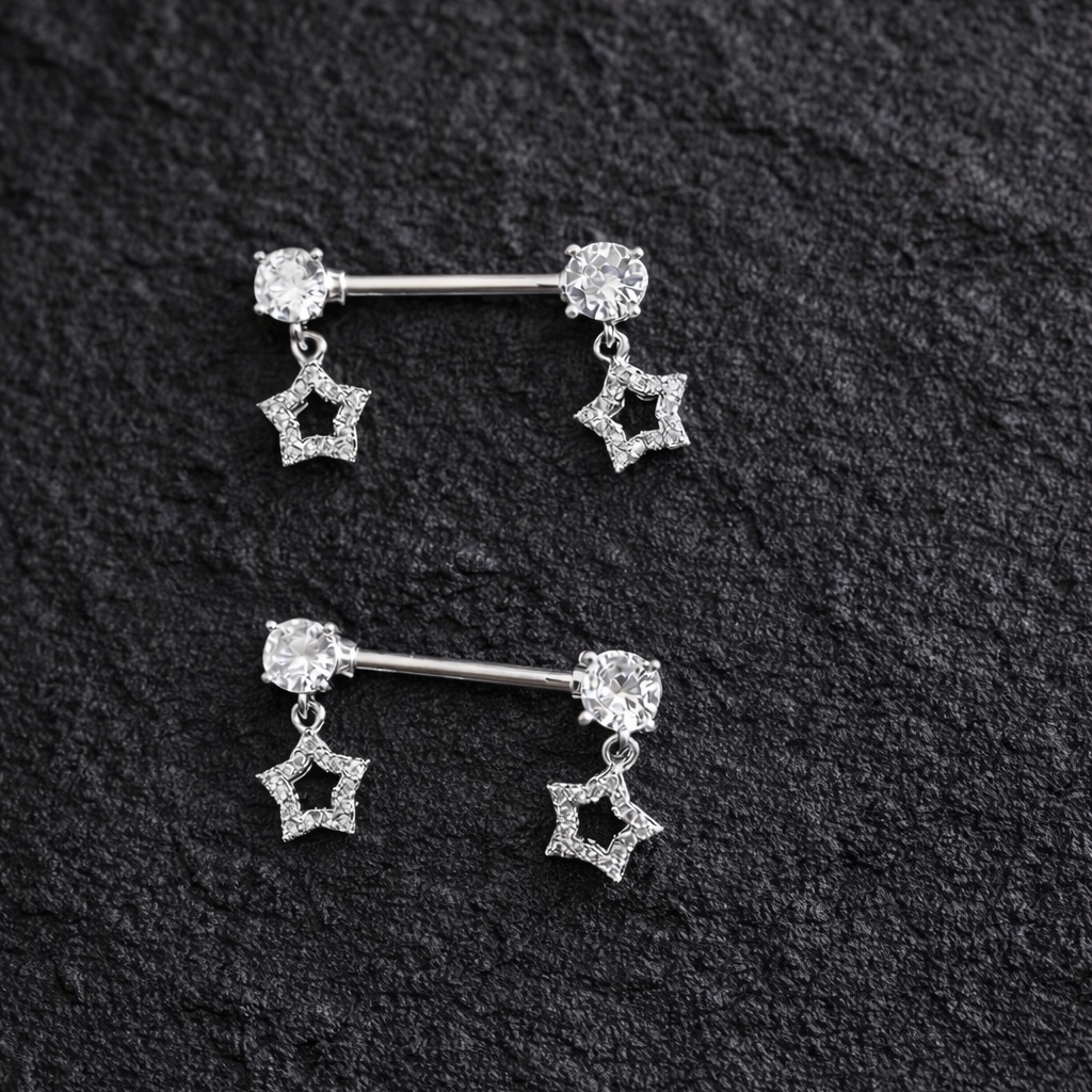 Pair of silver star-shaped nipple bars on a black textured background