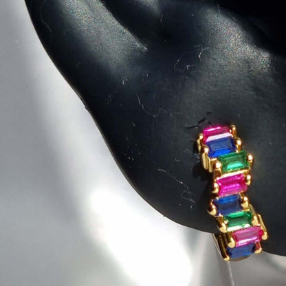 Rainbow earrings on ear