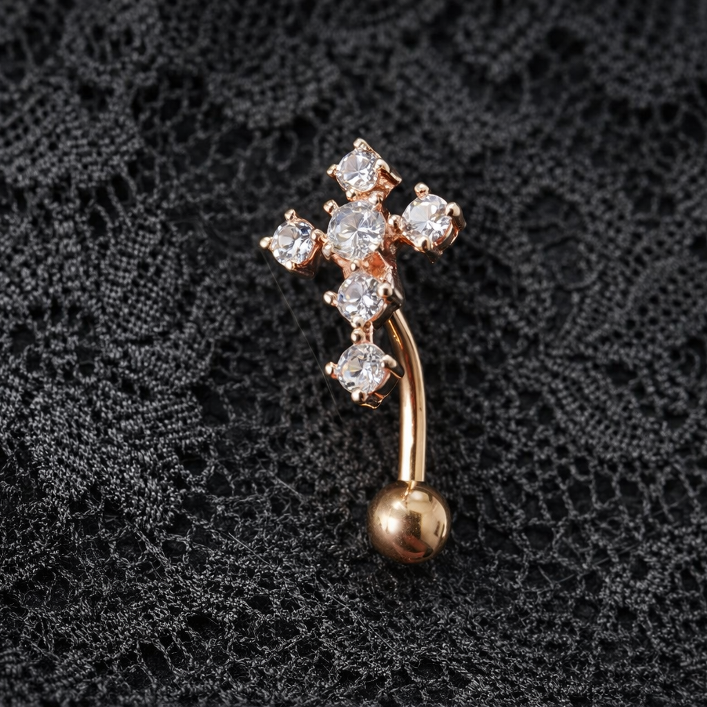 Rose Gold cross-shaped brooch with a dangling ball on a black lace background