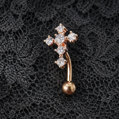 Rose Gold cross-shaped brooch with a dangling ball on a black lace background