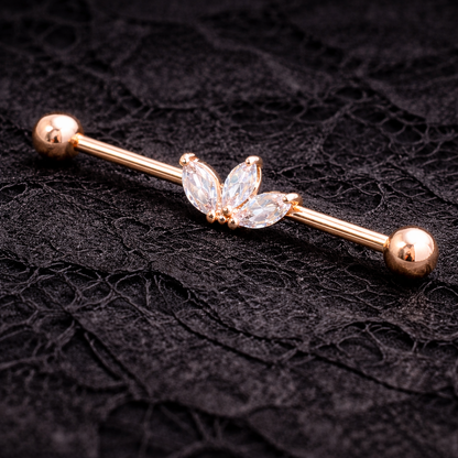 Rose gold industrial ear ring with butterfly design on a black textured background