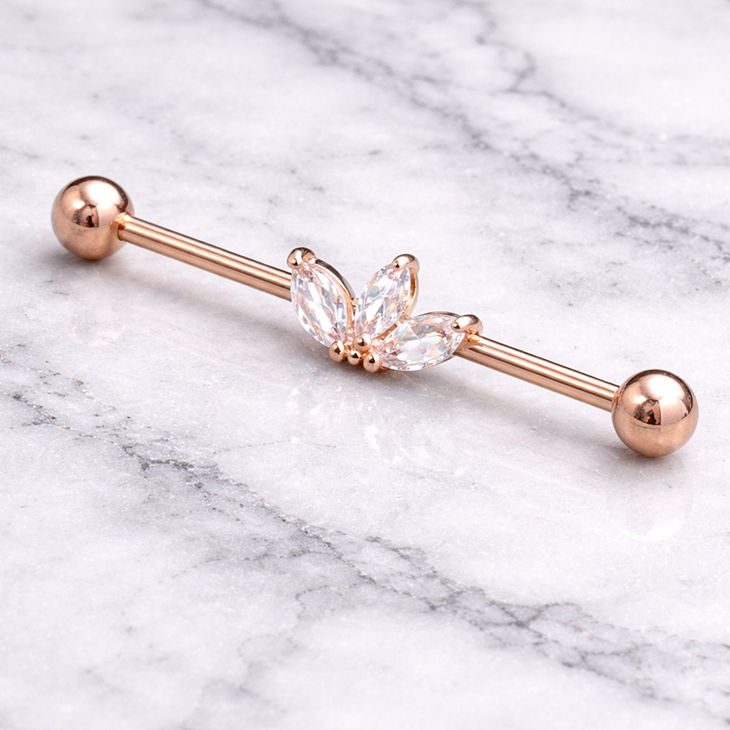 Rose gold industrial barbell with butterfly-shaped crystal on a marble background