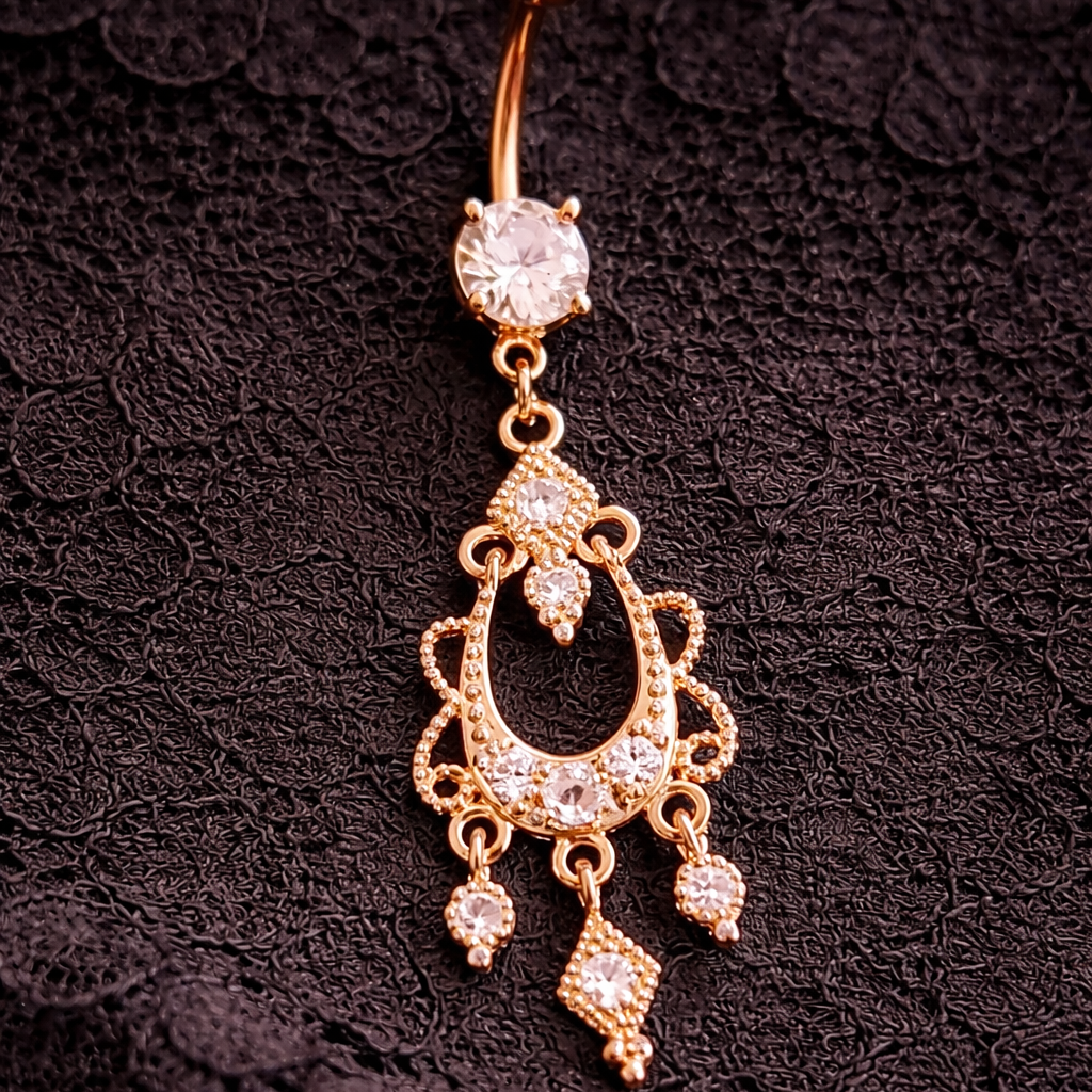 Decorative belly button ring with gemstones on a black lace background