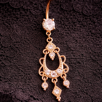 Decorative belly button ring with gemstones on a black lace background