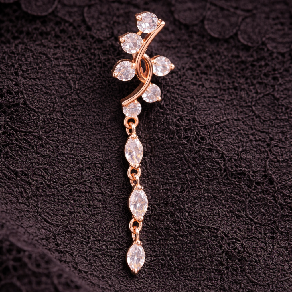 Rose gold belly button ring  with clear stones on a dark textured background