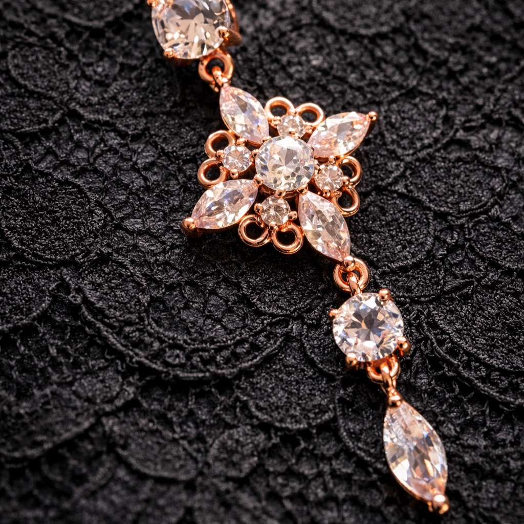 Rose gold belly button ring with crystal-like stones on a black textured background