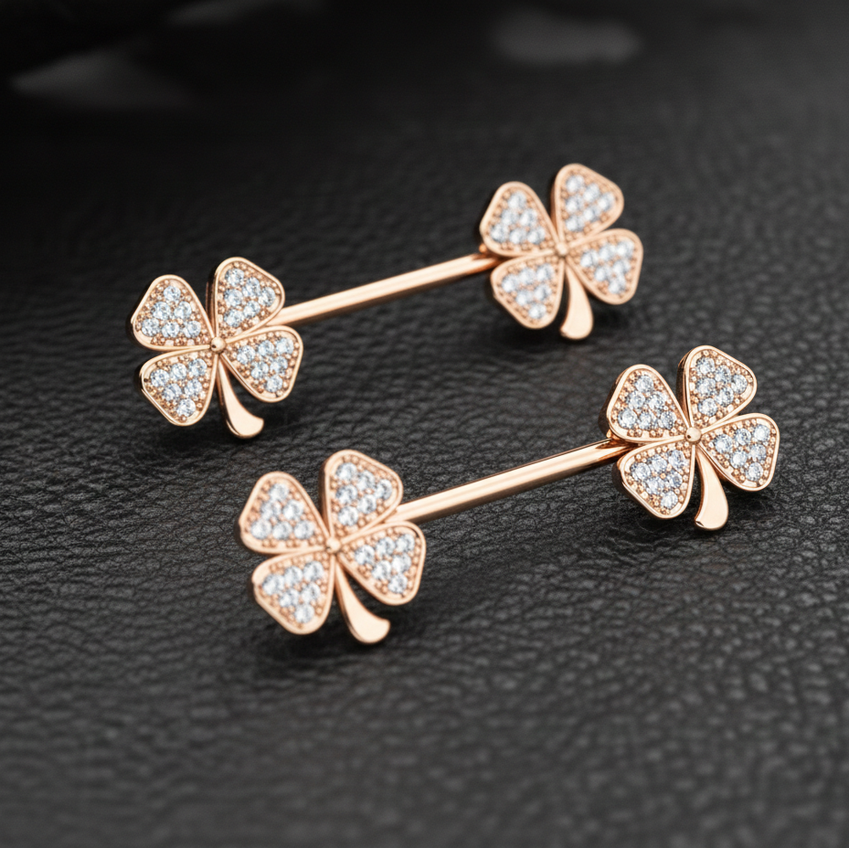 Rose gold four-leaf clover nipple bar on a dark textured background