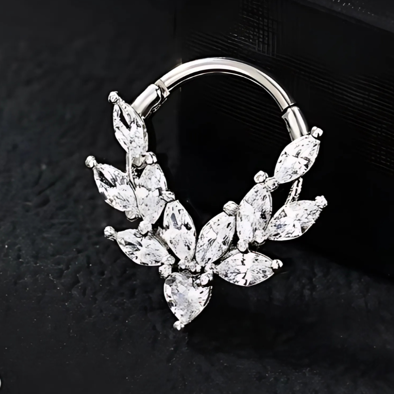 A silver 16g clicker ring for septum and daith piercings, featuring sparkling cubic zirconia stones, crafted from 316L surgical steel.