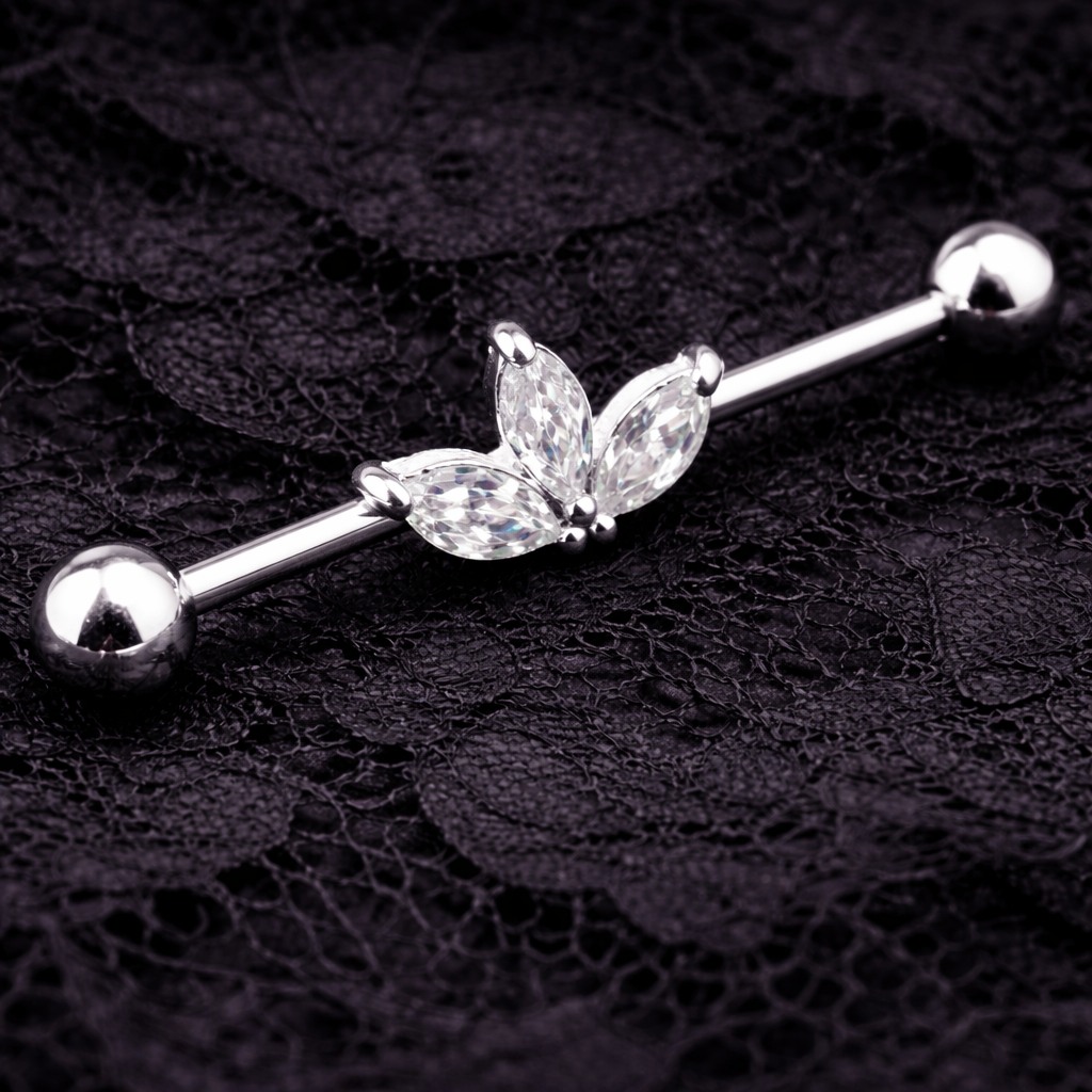 Stainless steel industrial ear ring with clear gemstones on a black lace background