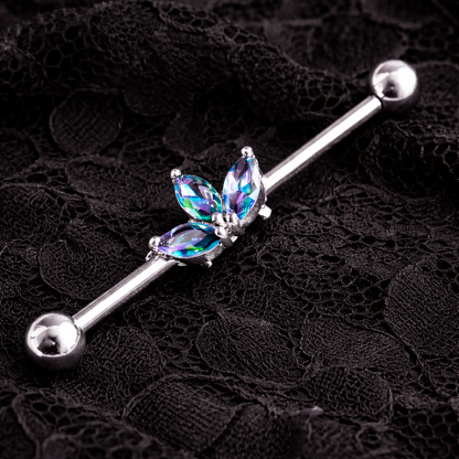 Butterfly-shaped industrial ear ring with gemstones on a black lace background