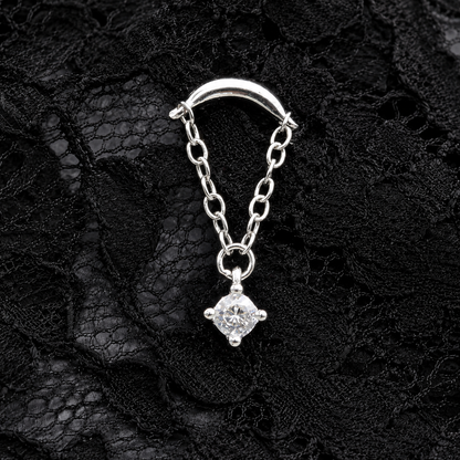 Silver chain with a diamond pendant on a black lace background