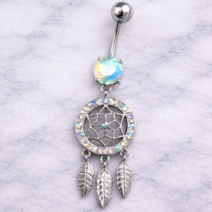 Belly button ring with dreamcatcher design on a marble background