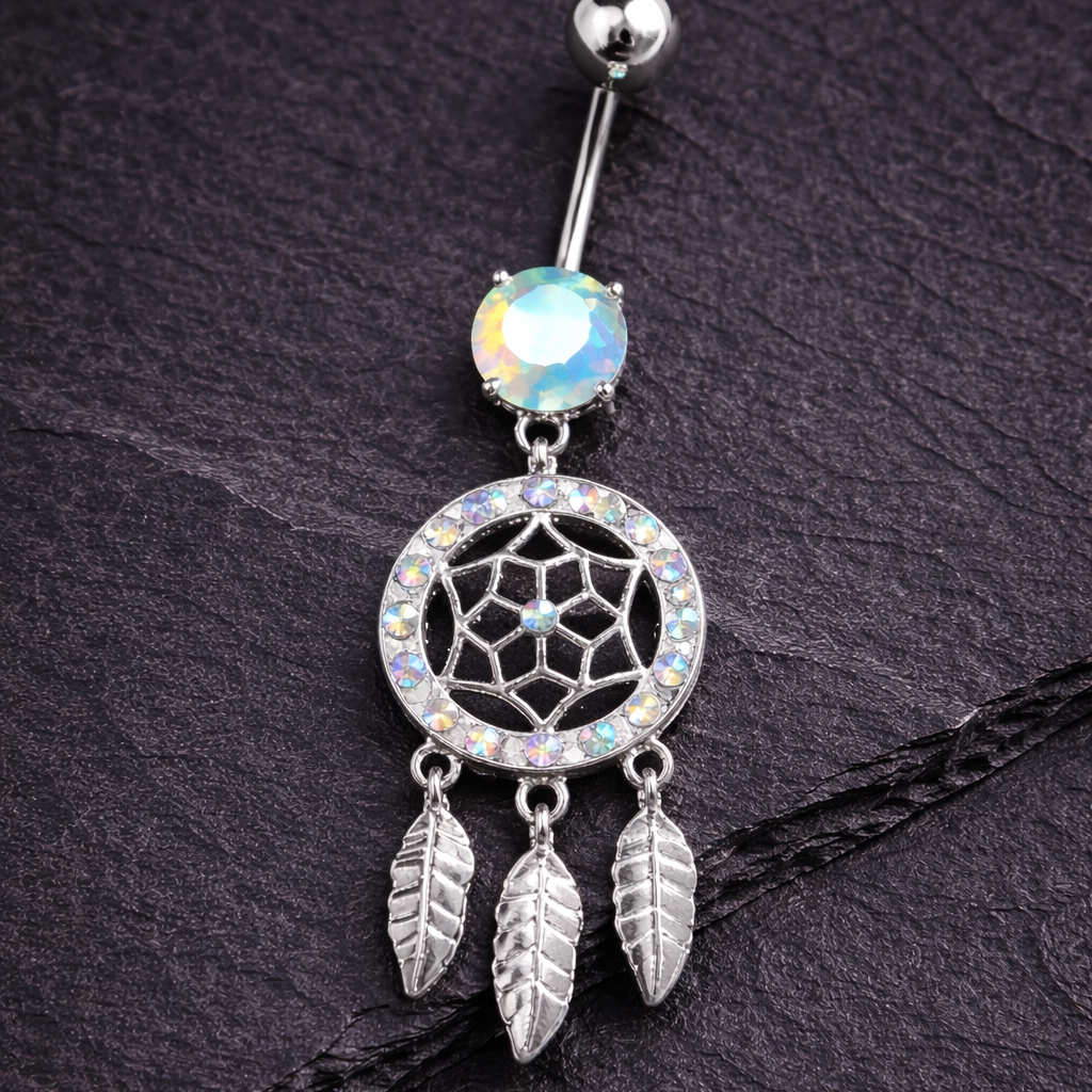 Silver belly button ring with dreamcatcher design on a dark textured background