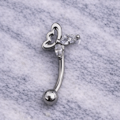 Silver eyebrow/rook bar with butterfly design on a marble background