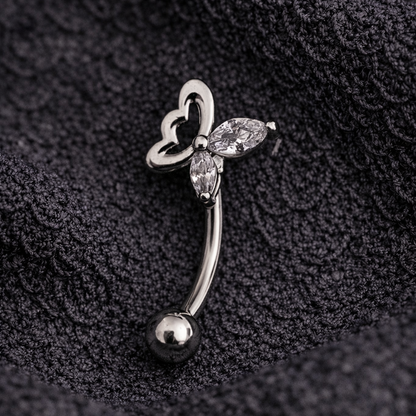 Silver eyebrow/rook barbell with butterfly design on a black textured background