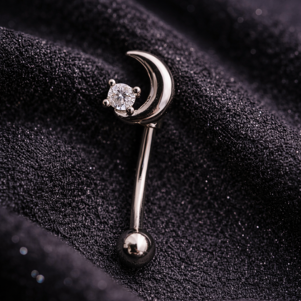 Silver eyebrow/rook barbell with moon and star design on black fabric