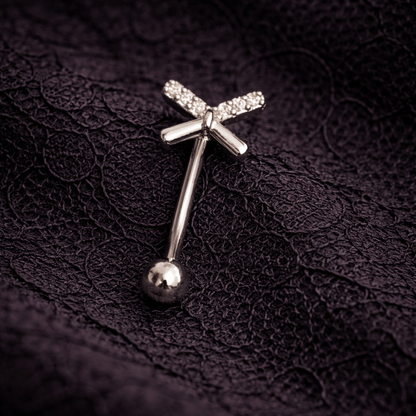 Silver eyebrow/rook piercing ring with a ball on a dark textured fabric background