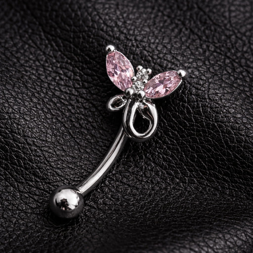 Silver eyebrow/rook piercing ring with pink butterfly wings on a black leather background