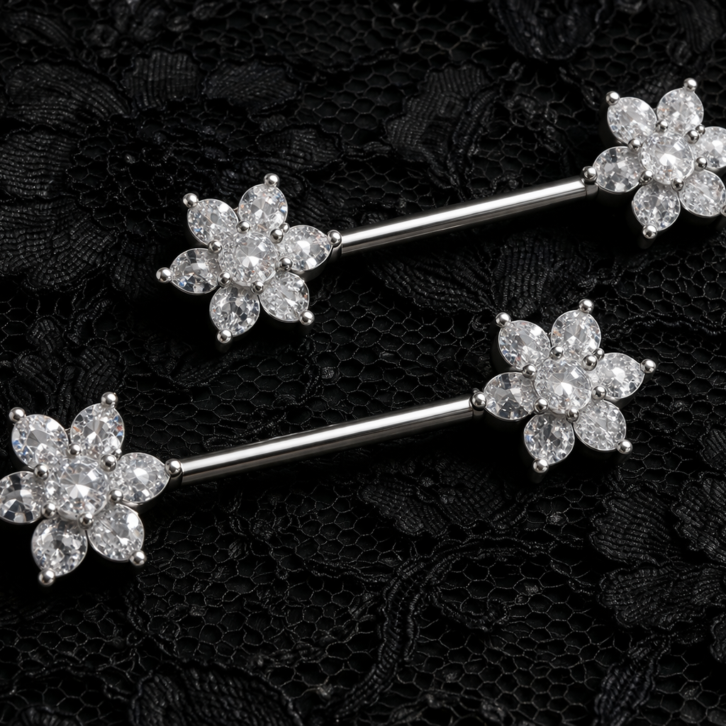 Silver floral nipple barbells on a black lace background