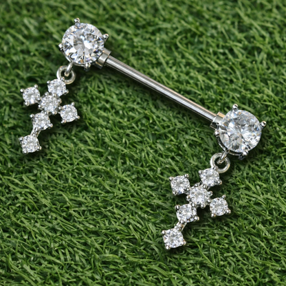 Silver nipple bars with diamond-like stones on a green textured background