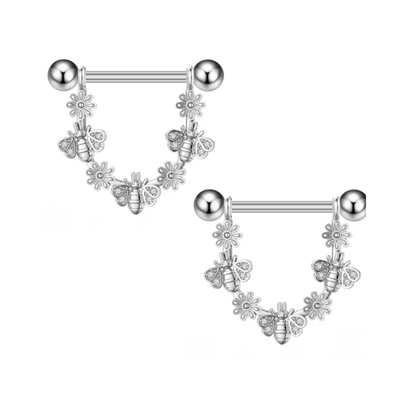 Silver nipple ring with floral and bee design on a white background