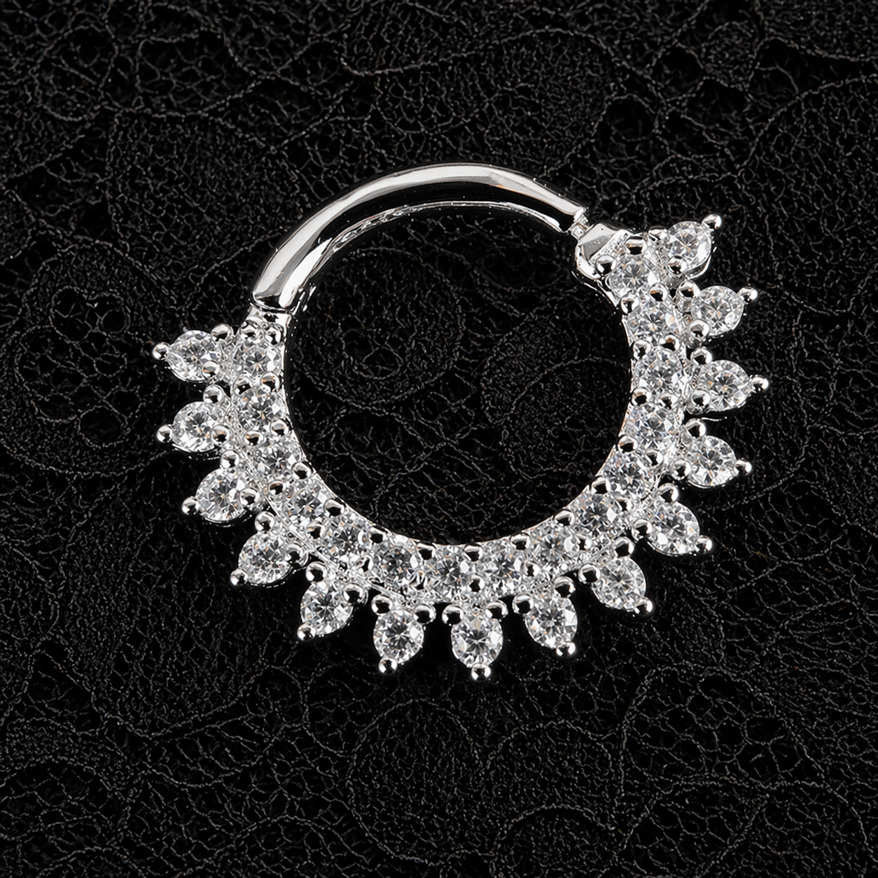 Silver nose ring with floral design on a black background