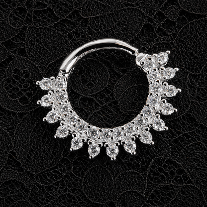 Silver nose ring with floral design on a black background
