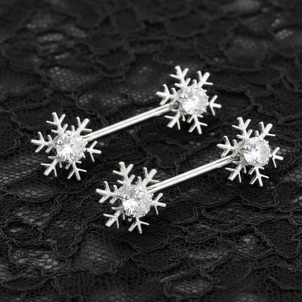 Silver snowflake-shaped nipple bars on a black lace background
