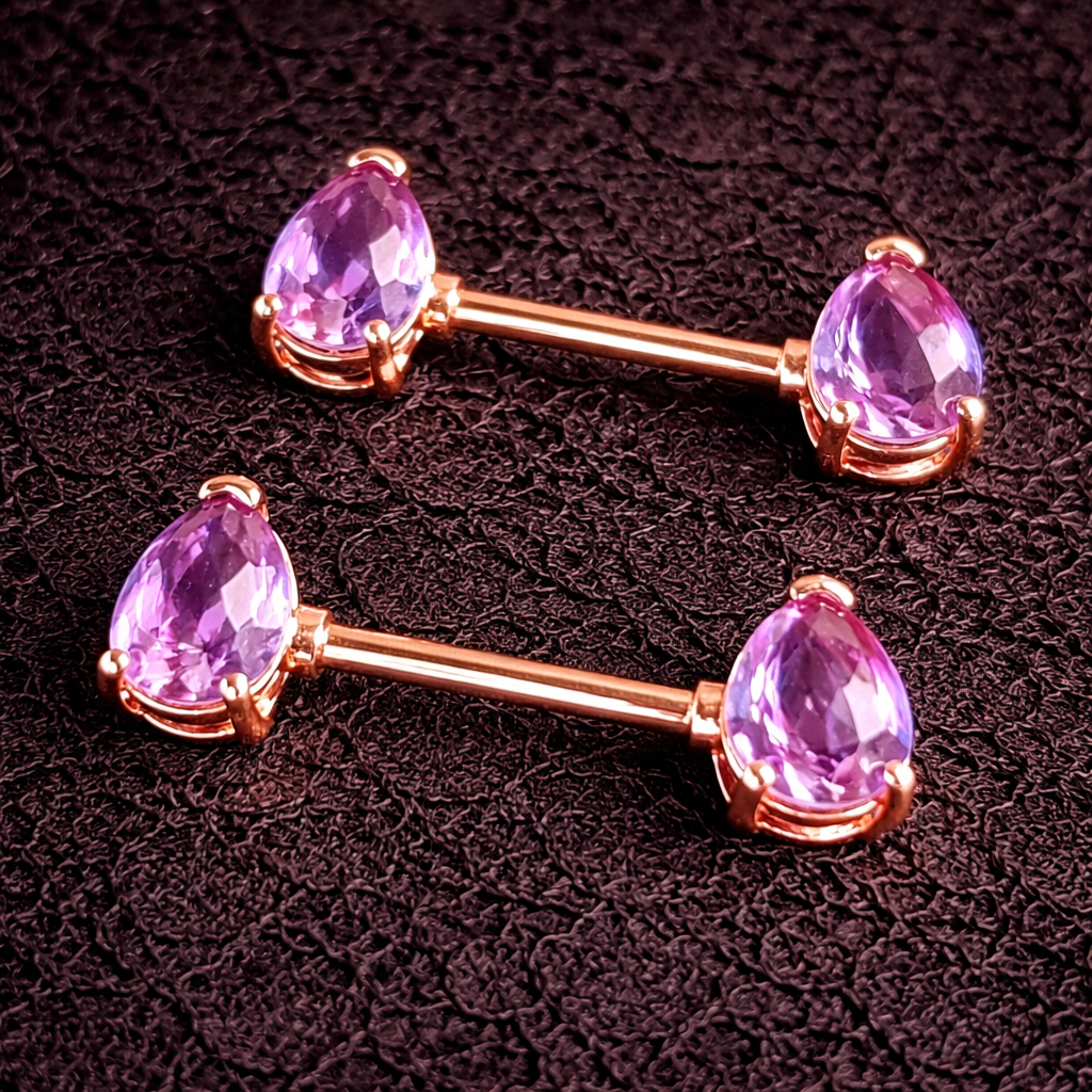Two rose gold nipple barbells with purple gemstones on a dark textured background