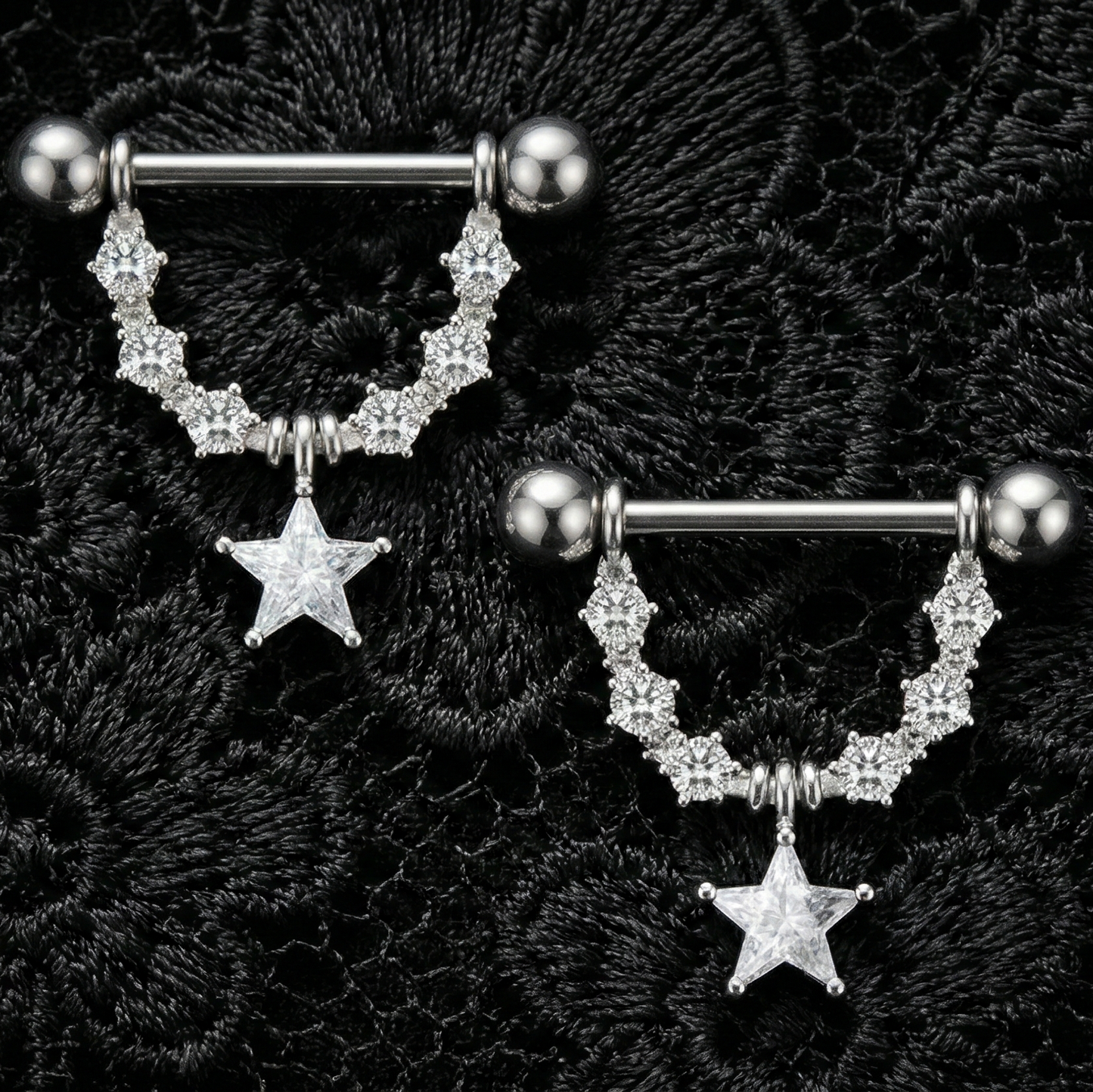 Two silver nipple bars with star charms on a black textured background