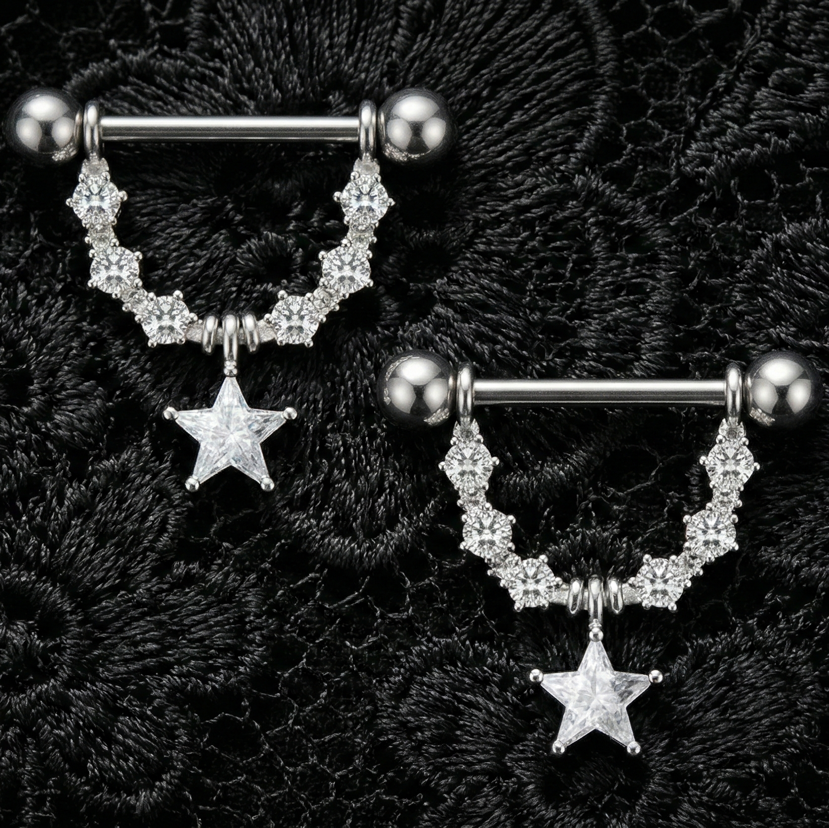 Two silver nipple bars with star charms on a black textured background