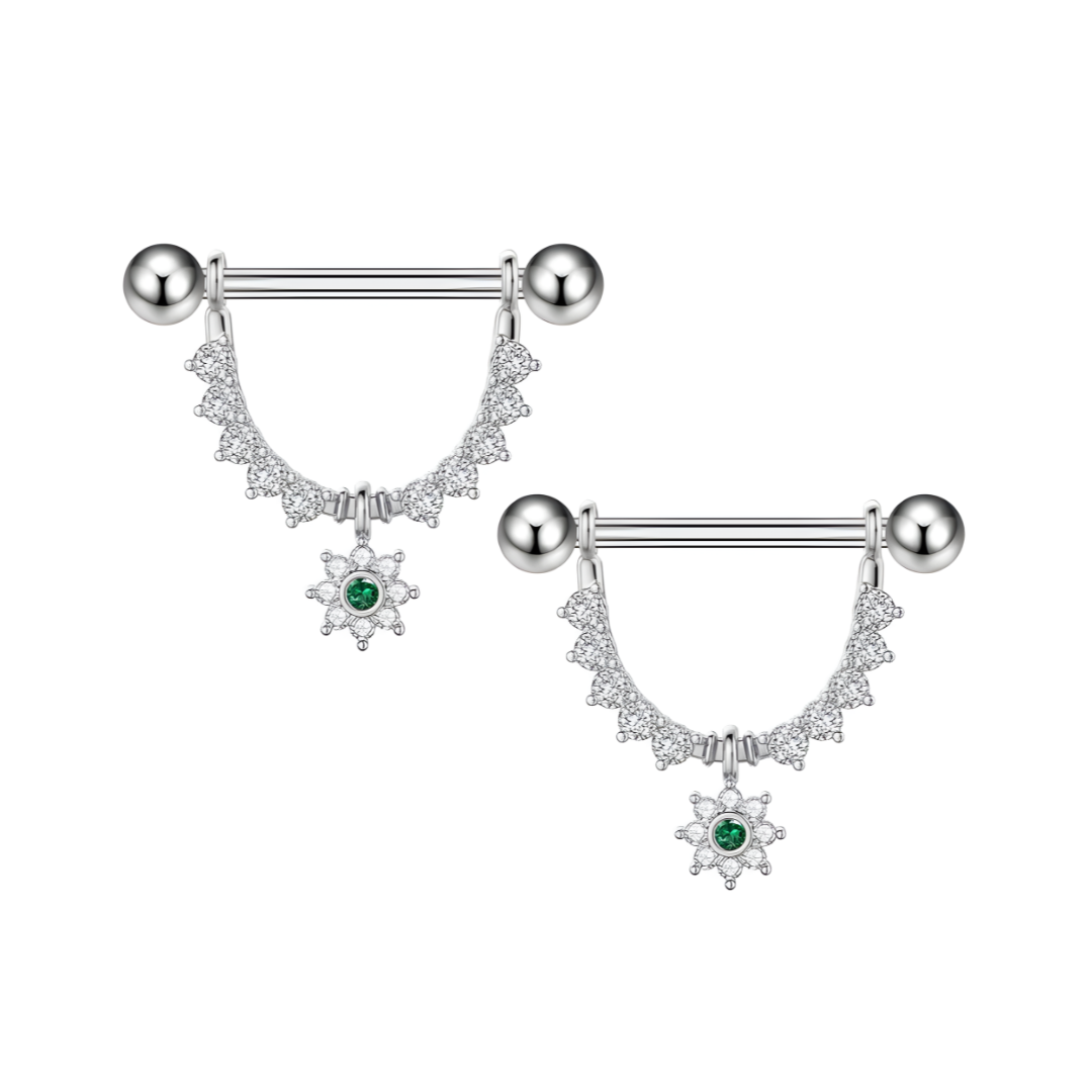 Pair of silver 14G surgical steel nipple bar shields with hanging flower design and green-centred crystal.