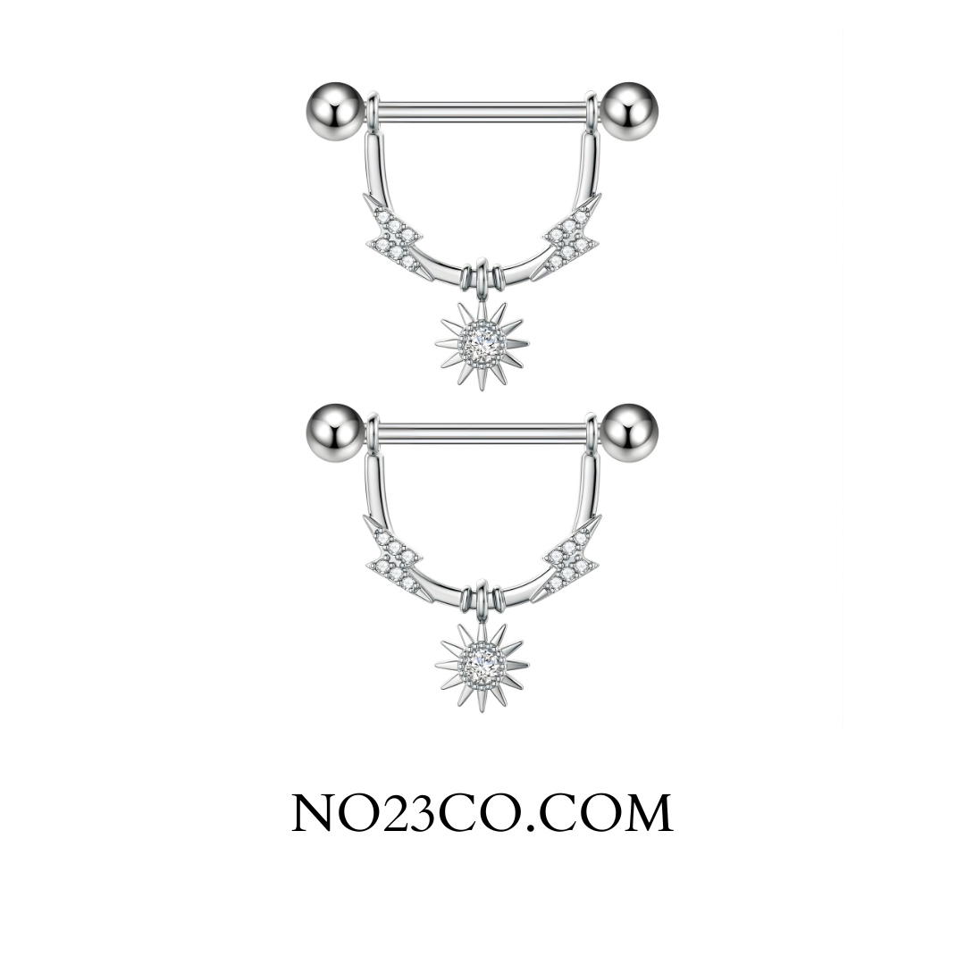 Close-up of star dangle nipple bar detailing clear cubic zirconia and polished 316L steel finish.