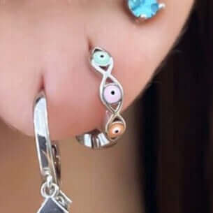 Evil eye hoop earrings on ear